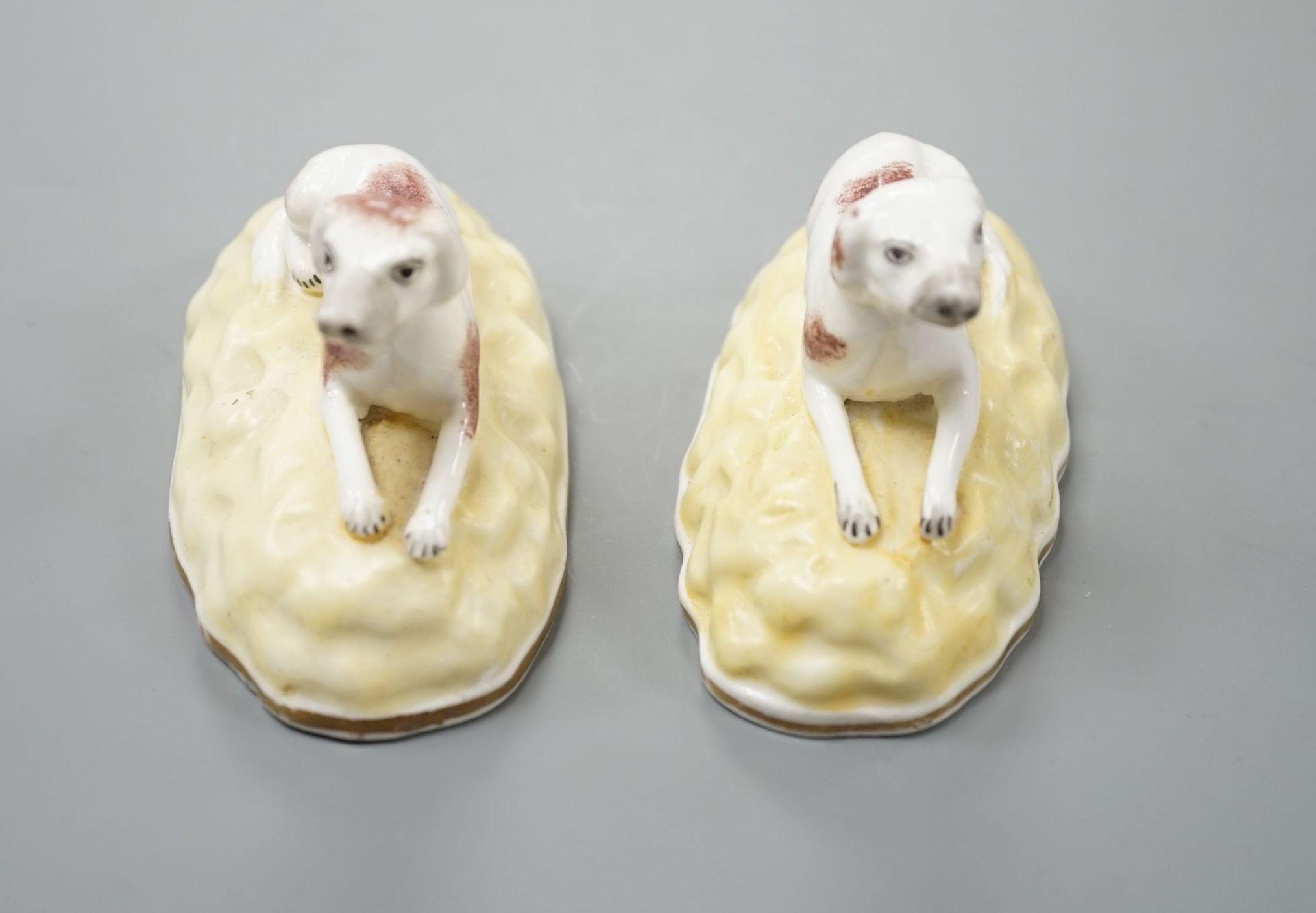 A rare pair of Samuel Alcock porcelain models of recumbent pointers, c.1835–50, impressed mark ‘115’, 8.8 cm long, Unrecorded in Dennis G.Rice Dogs in English porcelain., Provenance: Dennis G.Rice collection